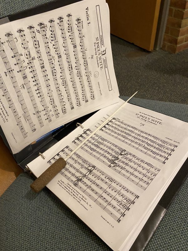 Musical score with conductor's baton lyin gon top